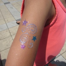 W's glitter tattoo from the Festival